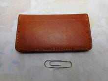 Load image into Gallery viewer, A charming tan leather stamp / card case embossed with a row of dogs