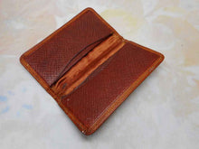 Load image into Gallery viewer, A charming tan leather stamp / card case embossed with a row of dogs