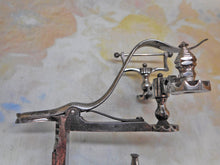 Load image into Gallery viewer, A cut steel hemming clamp with netting post and reel holder. Dated 1857.