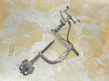 Load image into Gallery viewer, A cut steel hemming clamp with netting post and reel holder. Dated 1857.