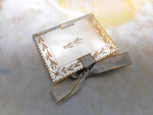 Load image into Gallery viewer, An engraved mother of pearl needle case in the form of a book. c 1850