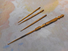 Load image into Gallery viewer, Four gilt steel crochet hooks and the universal handle. c1860.