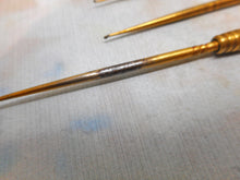 Load image into Gallery viewer, Four gilt steel crochet hooks and the universal handle. c1860.