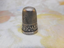 Load image into Gallery viewer, A silver thimble embossed with a band of flowers. c 1835
