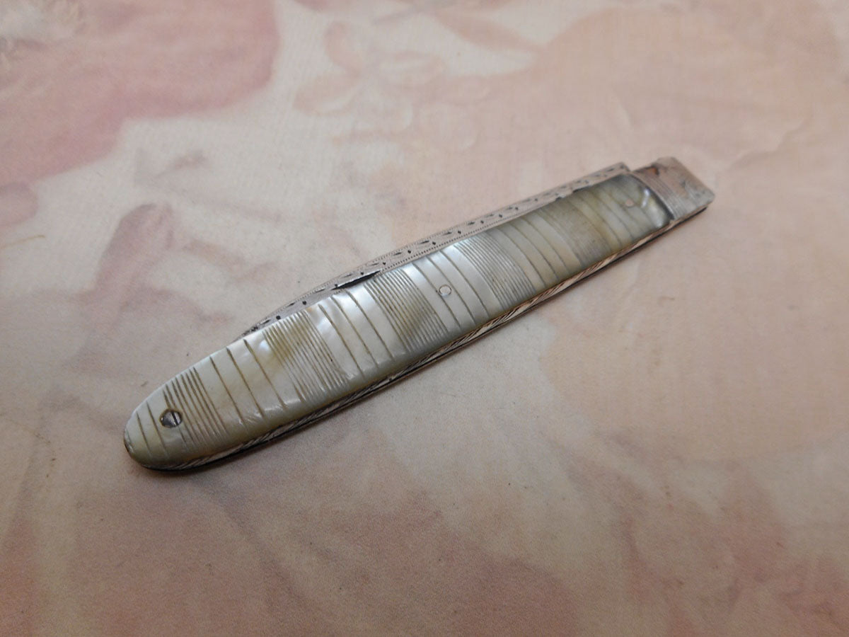 A folding fruit knife with engraved pearl sleeves. c 1800