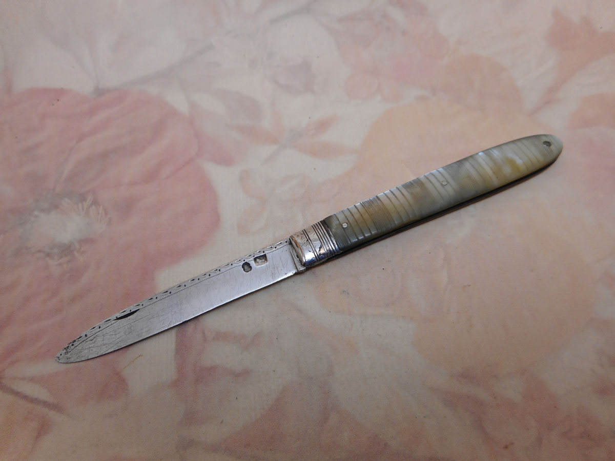 A folding fruit knife with engraved pearl sleeves. c 1800