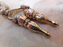 Laden Sie das Bild in den Galerie-Viewer, A pair of Dutch gold knitting needle protectors. c 1860