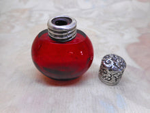 Load image into Gallery viewer, A small ruby glass scent / salts bottle with an embossed silver lid.  19thc