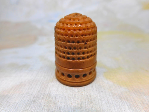 A thimble carved from a palm tree nut. c1850