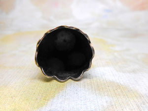 A silver thimble with a raised decorative border. c1870