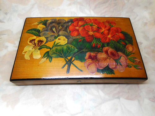 A florally painted card box with two packs of unused cards. c1900