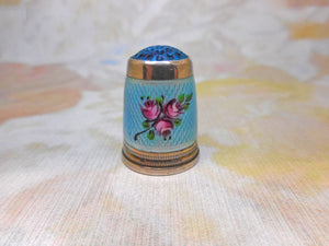 An American silver thimble with enamel decoration. c 1915