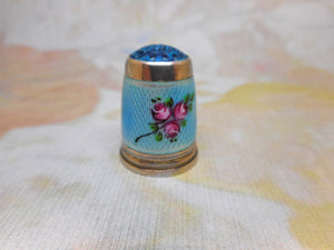 An American silver thimble with enamel decoration. c 1915