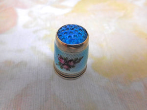 An American silver thimble with enamel decoration. c 1915