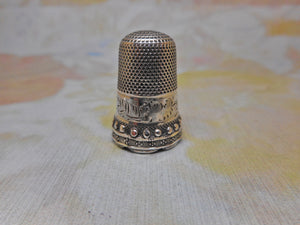 A decorative unmarked silver thimble. c1860-1870