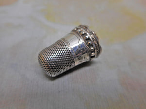 A decorative unmarked silver thimble. c1860-1870