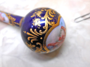 A Continental porcelain parasol handle painted with cherubs. c1880