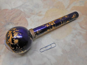 A Continental porcelain parasol handle painted with cherubs. c1880