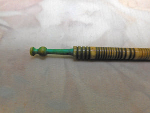 A dyed green 19th century lace bobbin.