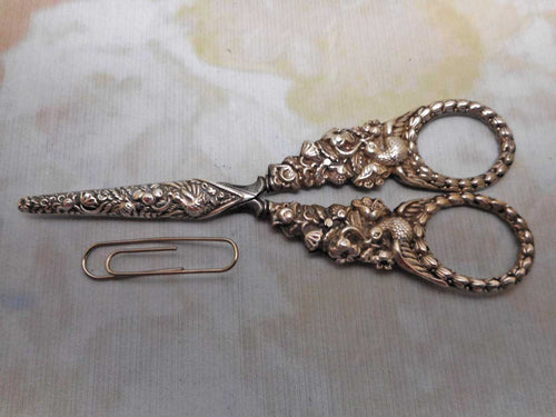 A pair of silver 'bird' handled scissors and sheath. c 1830-1840