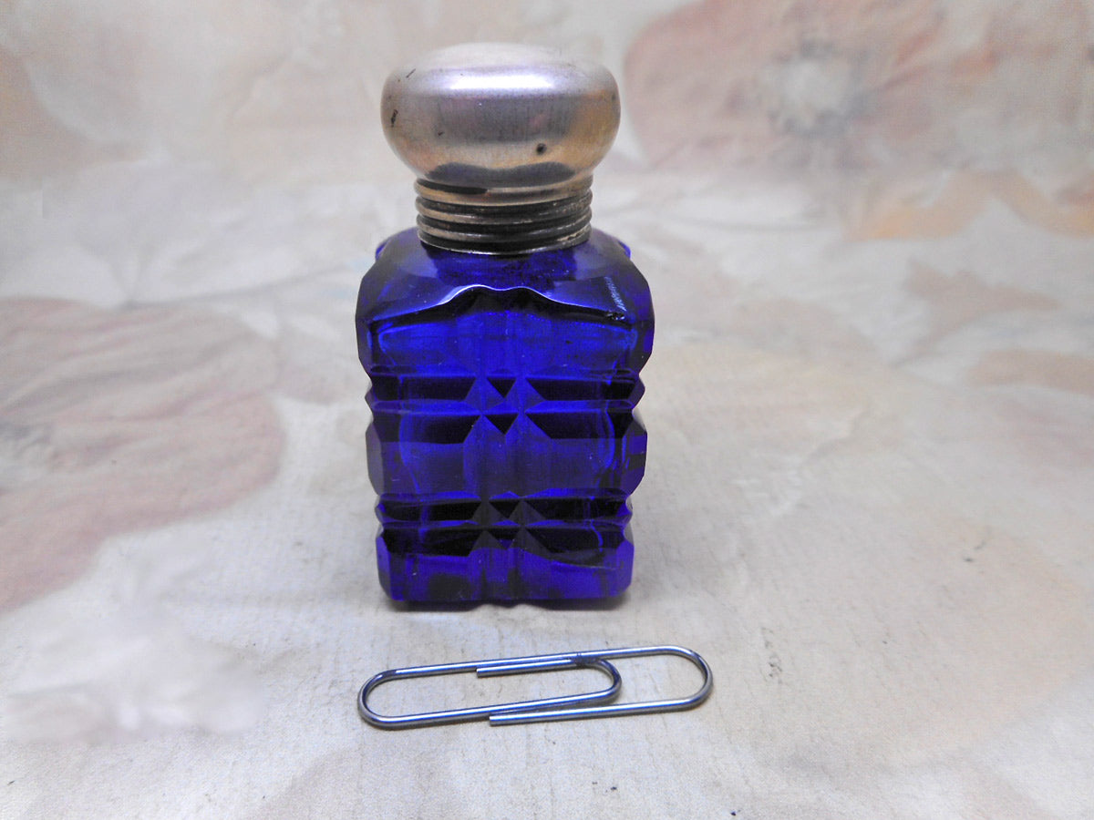 SOLD……A cut glass scent bottle with a silver lid. c 1900