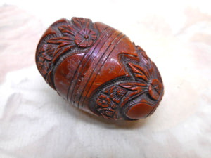 A good quality carved coquilla nut egg pomander. c 1850