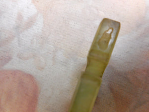 An unusual green stone thread winder. 19thc