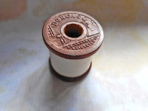 A pressed wood 'Dorcas' cotton reel / spool.
