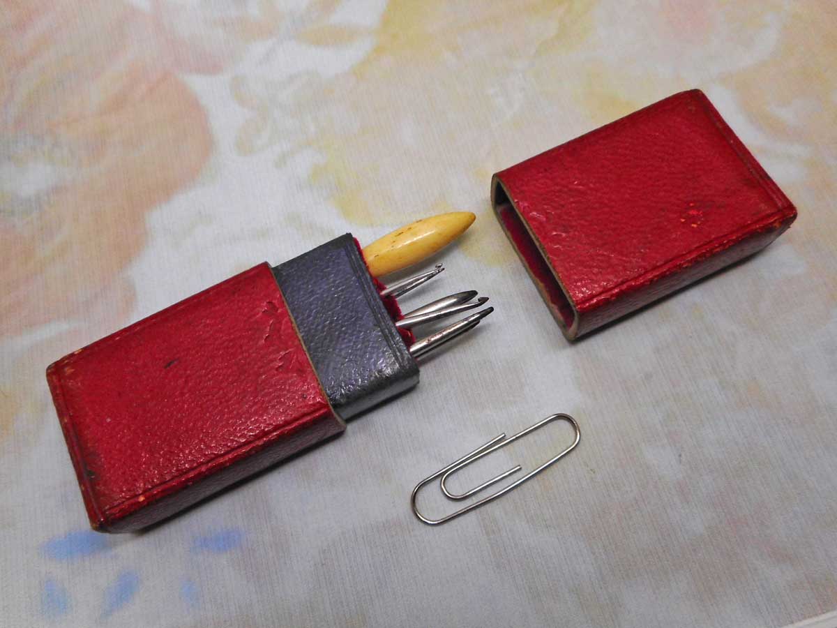SOLD…..       A crochet hook set in a red leather case. c 1850