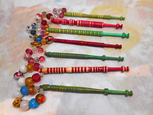 A group of 7 dyed bone lace bobbins. 19thc