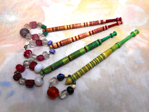 Four dyed bone lace bobbins with decorative turning. 19th century.