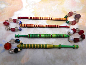 Four dyed bone lace bobbins with decorative turning. 19th century.