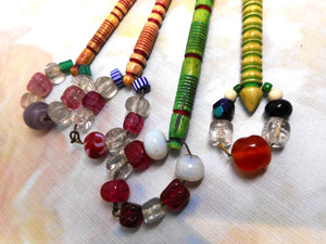 Four dyed bone lace bobbins with decorative turning. 19th century.