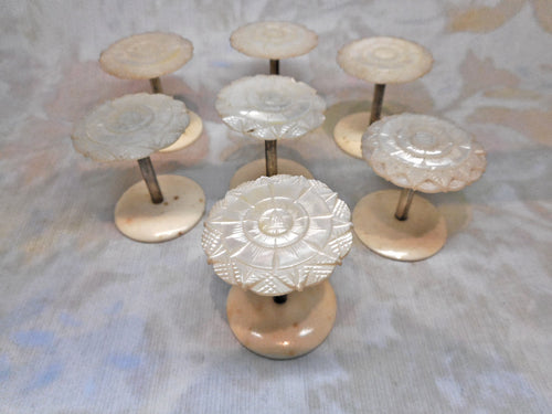 A matching set of 7 pearl topped reels / spools. Mid 19thc