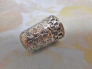 A decorative hall marked silver thimble. English c1890.