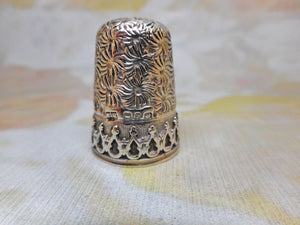 A decorative hall marked silver thimble. English c1890.