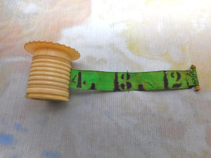 A pearl topped tape measure. c 1850