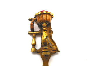 A figural hemming clamp. c1880-1900