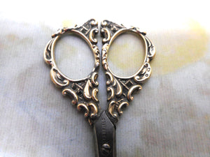 A pair of silver handled manicure scissors. HM. 1901.