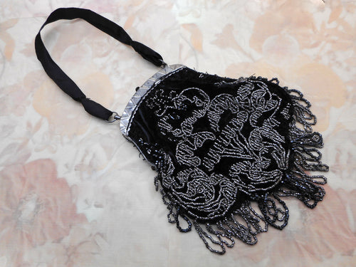 A black velvet bag with steel beading. c1850