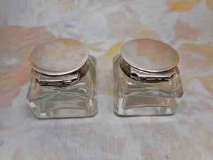 A pair of small ink wells with plated lids. c1880