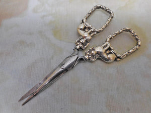 A pair of silver 'dog' handled scissors. c 1840