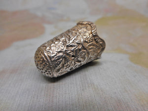 An Indian silver thimble in a leather case. c 1880