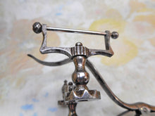 Load image into Gallery viewer, A cut steel hemming clamp with netting post and reel holder. Dated 1857.
