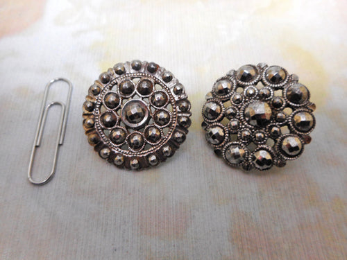 Two cut steel buttons.