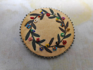 A Georgian silk pin cushion disc with beadwork. c 1820