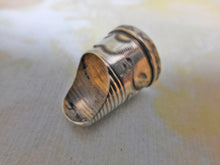 Load image into Gallery viewer, An engraved silver finger guard / thimble. Mid 19th century.
