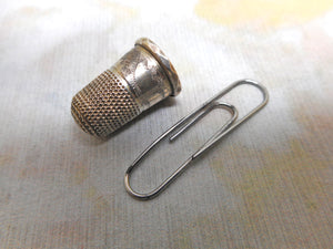 A very small silver thimble for a child. c 1840