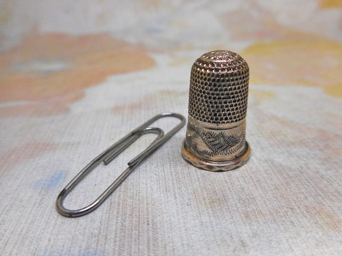 A very small silver thimble for a child. c1840