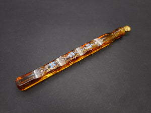 An amber glass scent bottle with enamelling.  Lachrymatory / Tear catcher